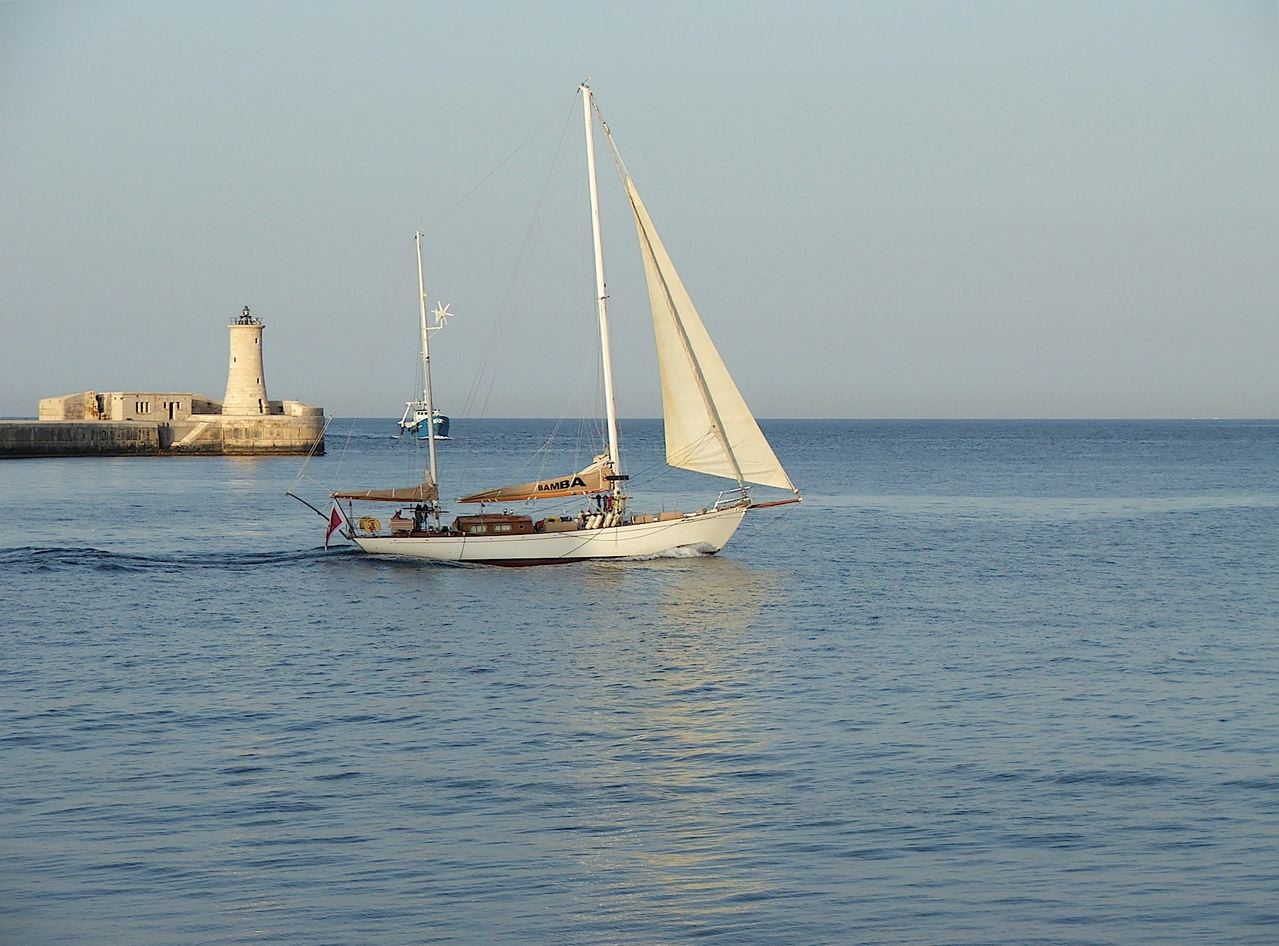 A yacht sailing out of the Grand Harbour